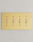 Solid brass Futura Toggle Wall Plate – Quad in Polished Brass finish