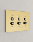 Solid brass Futura Push Button Wall Plate – Triple in Polished Brass finish