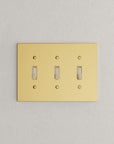 Solid brass Futura Toggle Wall Plate – Triple in Polished Brass finish