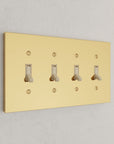 Solid brass Futura Toggle Wall Plate – Quad in Polished Brass finish